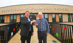 Councillor Bryan Poole accepts the keys to the new Burntisland Primary School from Martin Cooper.