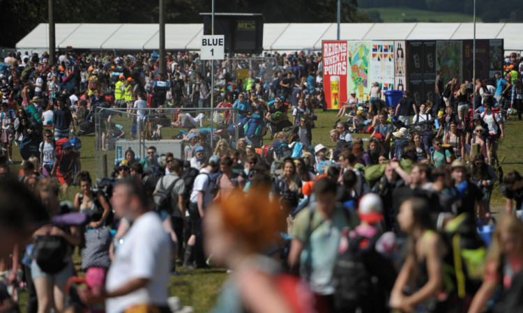 Thousands of campers make their way from the drop off points to the main camp site at T in the Park.