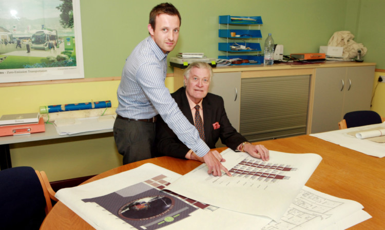 Michael Leeland and Michael Johnston discussing detail on a drawing.