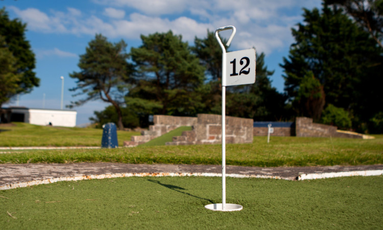 The crazy golf course at Castle Green is a popular attraction on a sunny day.