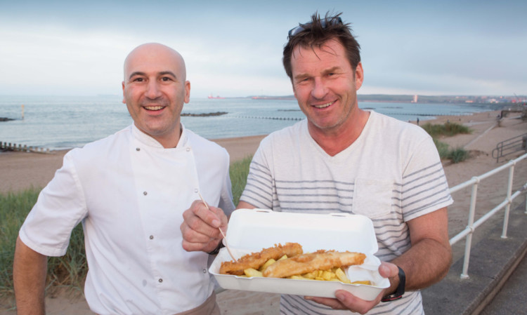 Sir Nick enjoying his fish and chips with owner Alex Grahame.