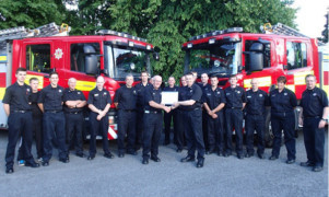 Ronnie Black, left, being presented with his retirement certificate by group manager Rab Middlemiss, watched by his Pitlochry and Dunkeld colleagues.