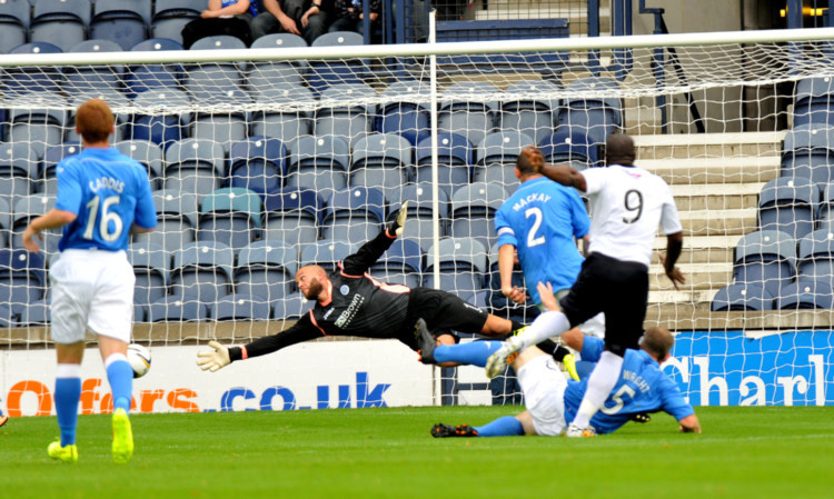 St Johnstone goalkeeper Alan Mannus is beaten by a Christian Nade strike.