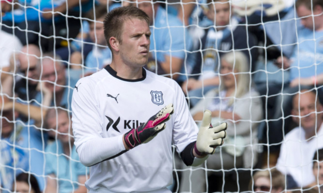 Grant Adam in goal for Dundee against Manchester City last weekend.