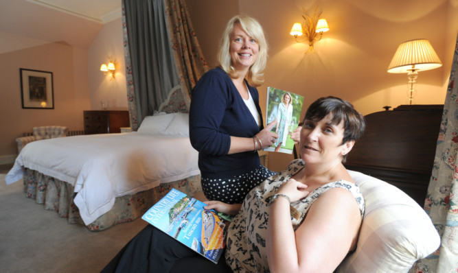 Scone Palace staff Margo Baird and Heather McArthur in the master bedroom.