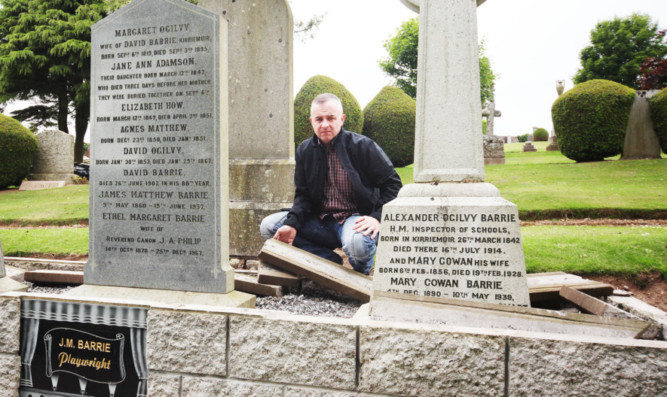 Kirriemuir Community Council chairman David Milne with the broken coping stones at JM Barrie's grave.