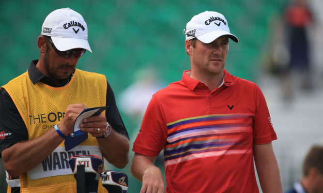 Marc Warren chats to his caddie.