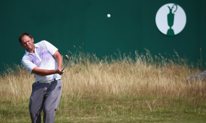 Jamie McLeary hits a pitch shot to the 18th green.