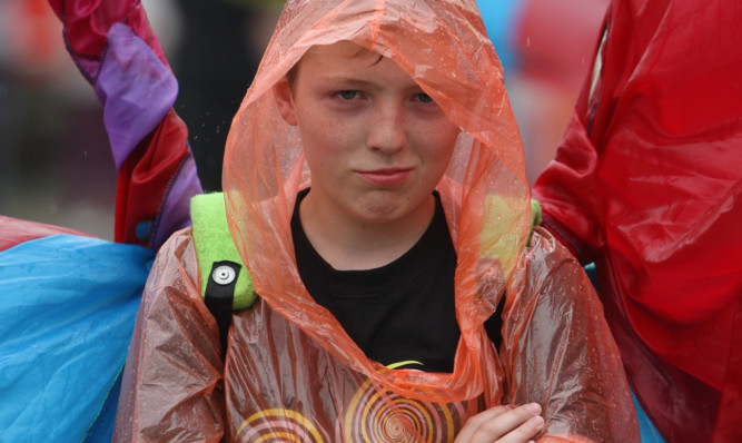 One of the young parade members struggles to see the funny side of the weather.