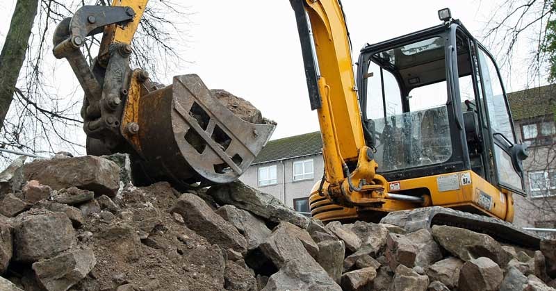 A digger with the remains of the historic wall at Clement Park Place, Dundee, which has been demolished.