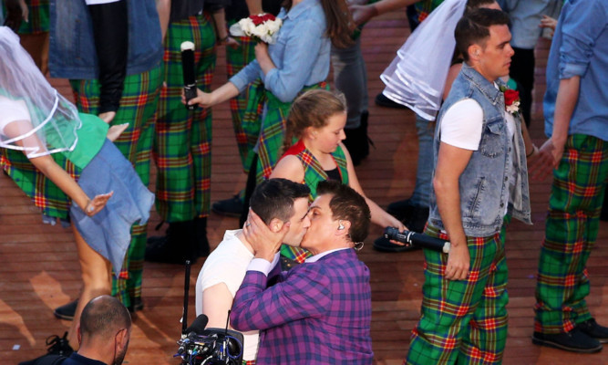 John Barrowman plants his kiss during the opening ceremony.
