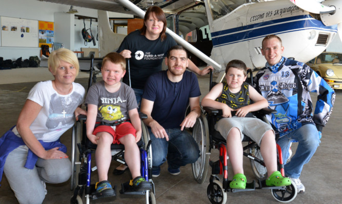 From left: Lorraine Headspeath, Ben Stewart, Cheryl Myles, Gerard Doran, Cameron McKenzie and Barry Kinnell at Fife Airport, Glenrothes, preparing for a tandem sky dive to send the two eight-year-old boys to Lapland.