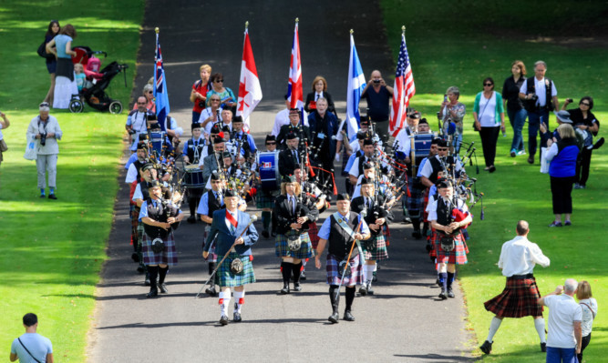 The Can-Am Pipes and Drums band marched down Scone Palaces drive.