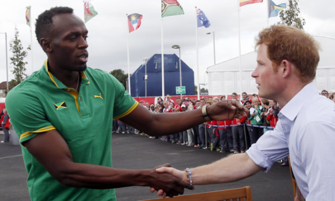 Usain Bolt meets Prince Harry during during his visit to the Commonwealth Games Village.
