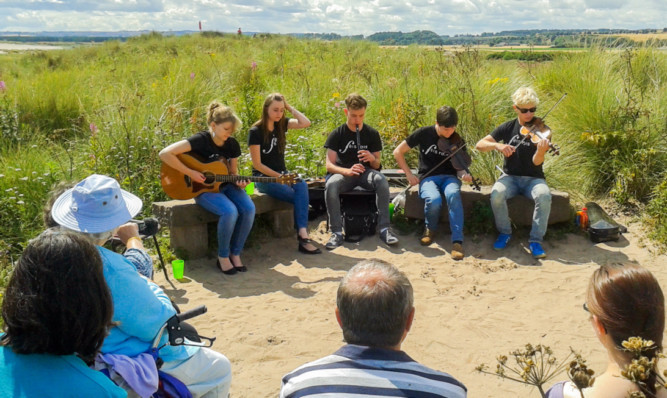 The Feis Rois National Ceilidh Orchestra perform on the beach by St Cyrus Nature Reserve. From left: Megan McKay, Ross Hull, Chris Coates, Ossian Green and Annie Lennox. Right, the orchestra in action.