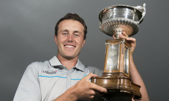 Winner Chris Robb proudly shows off the Scottish Amateur Championship trophy