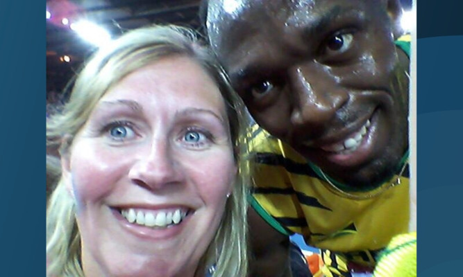 Gillian poses with the Jamaican sprinter.