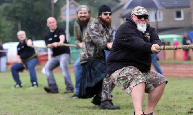 Duck Dynasty stars (from front) John Godwin and Jase Robertson take part  at Inverkeithing Highland Games.