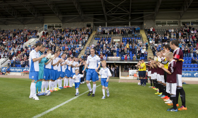 St Johnstone captain Steven Anderson exits the tunnel alongside his sons.