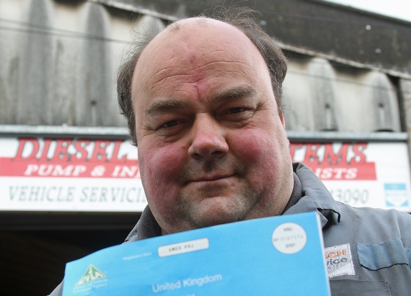 Kim Cessford, Courier - 30.04.10 - pictured with a typical car registration document that fooled him into buying a stolen car that cost him £12,000 is Gregor Lawson outside his business 'Diesel Fuel Systems' in Peddie Street