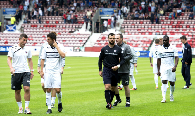 Raith Rovers striker Christian Nade, right, walks off at East End Park after a freak thunderstorm hit their derby clash with Dunfermline.