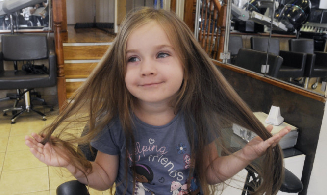 Emma gets ready to say goodbye to her long hair.