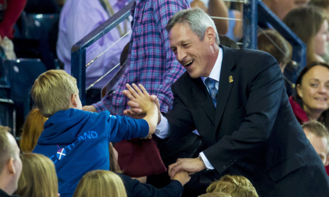 Scottish sprint legend Alan Wells greets a young fan at the Commonwealth Games last week. The 1980 Olympic gold medal-winning hero hopes the current crop of athletes can use Glasgow 2014 as a stepping stone to further glory.