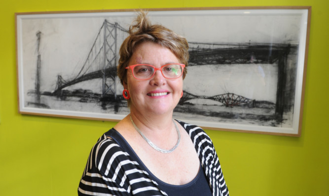 Artist Kate Downie with one of her images of the iconic road bridge.