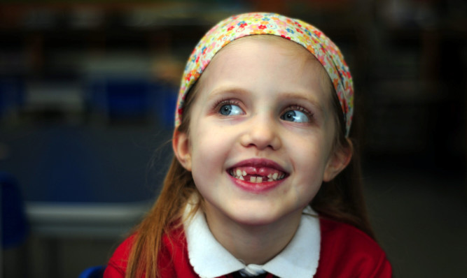 All smiles: Courageous Sophie at school.