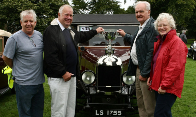 Ian and Fiona Reid receiving the award from judge Donald Ridgway for best pre-1930s car in the motor show for a 1926 Bullnose Morris Oxford. Also pictured is Jimmy McDonell from Dundee Museum of Transport.