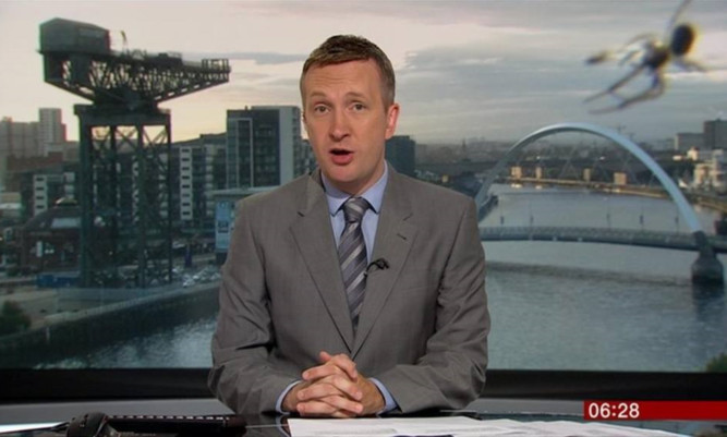 The spider appears behind BBC newsreader Graham Stewart during the early morning broadcast.