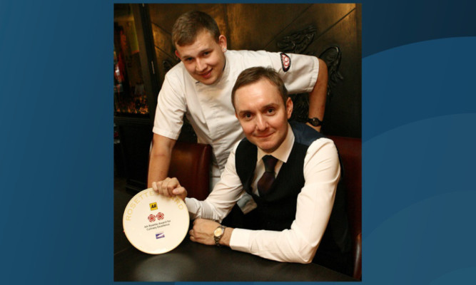 Restaurant owner Paul McMillan, seated, and head chef Adam Newth with the two AA Rosette award.