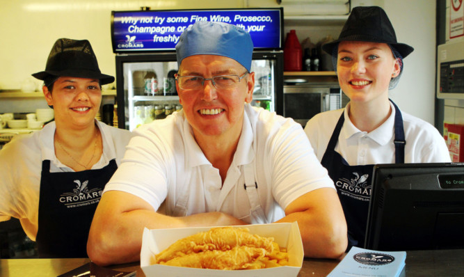 Shop owner Colin Cromar with staff members Marcia Alzamora and Freja Connell.