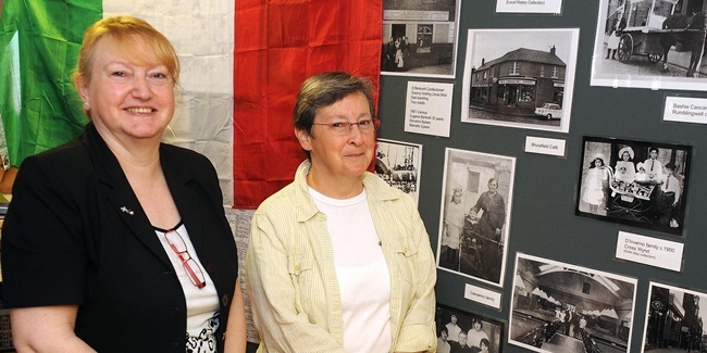 Eveline Vernolini and Norma Alari look at some of the pictures on display