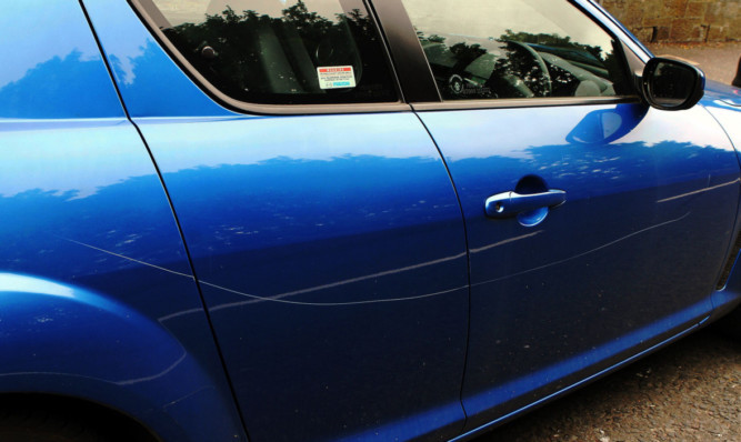 This Mazda in Albany Terrace had three panels scored by the vandal.