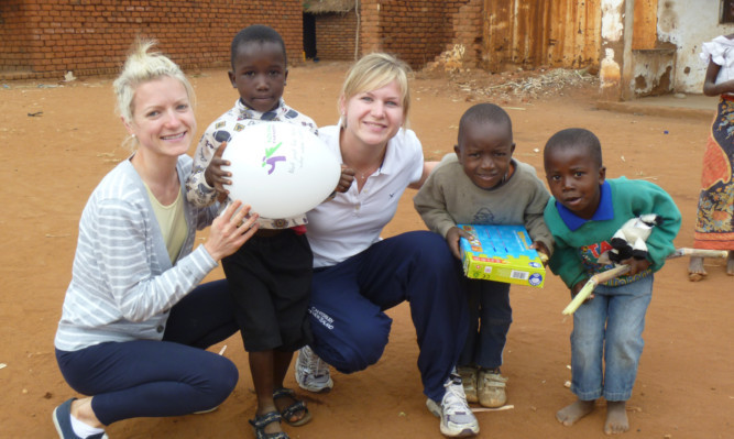 Left: Kirstene and Deborah with school children during the Malawi trip.