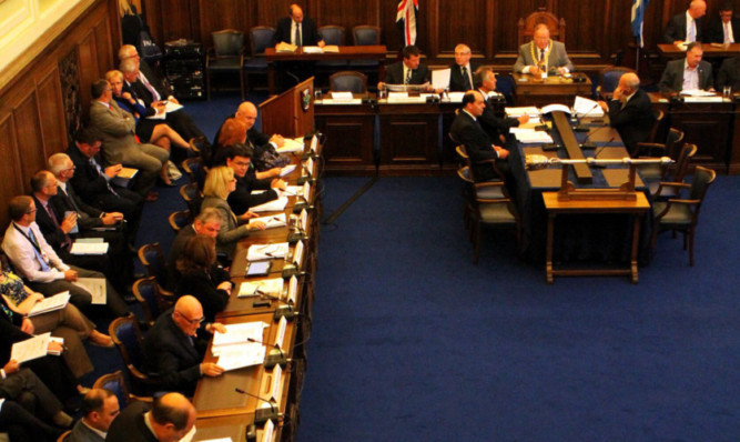 The council meeting in the City Chambers.