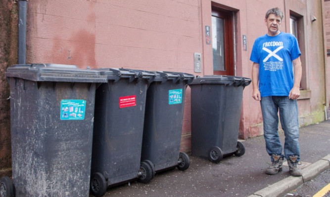 James Allan, whose bins have not been picked up by Angus Council from outside his home on Leonard Street.