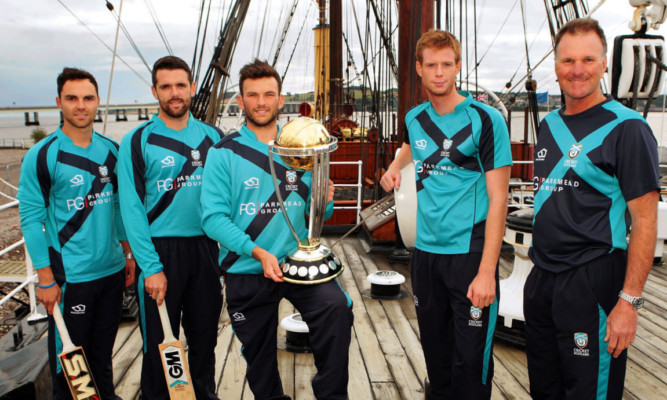 Scotland cricket team members Preston Mommsen, Gordon Goudie, Craig Wallace, Ally Evans and Grant Bradburn with the trophy on board the Discovery.