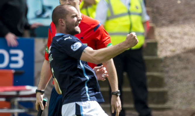 James McPake rushes to celebrate in front of the Dundee fans.