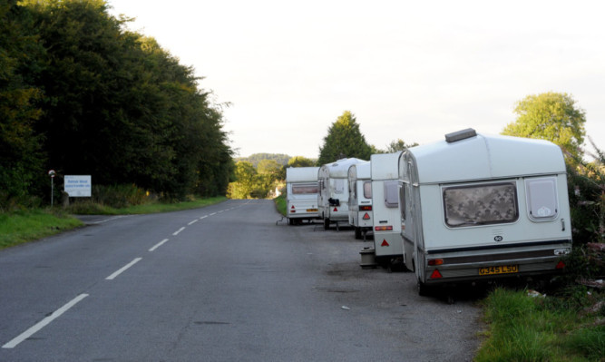 The illegal encampment of caravans in the layby opposite Balmuir Wood Travellers site.