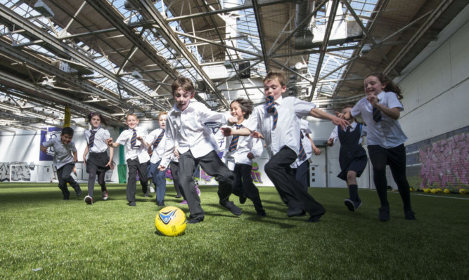 Pupils from Claypotts Primary School try out the new 3G pitch.
