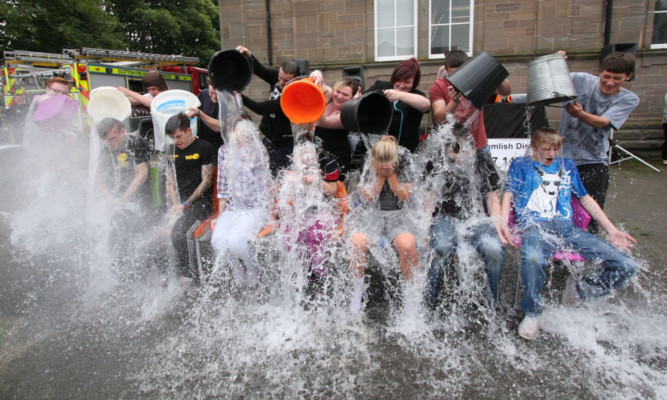 Students take a joint ice bucket challenge for charity.