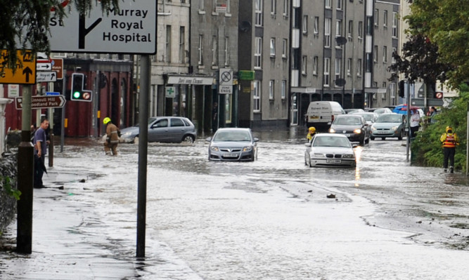 Firefighters helped to rescue motorists trapped by flooding in Bridgend, Perth, in 2011.