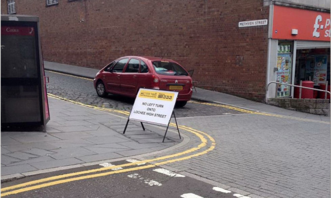 A sign warning motorists of the changes to Lochee High Street.