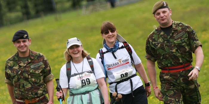 Kris Miller, Courier, 25/06/11. Picture today at Kirkmichael, Perthshire. Hundreds of people were walking the Cateran Trail as part of the Cateran Yomp to raise money for soldiersa charities. Pic shows L/R, Trooper Neil Guffick, Colleen Briggs, Debbie Birt and Lnc Cpl Daniel Hutchison nearing thew Kirkmichael check in.