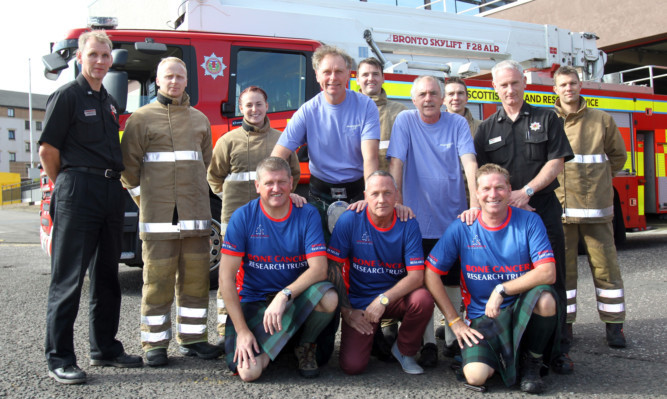 Ex-firefighters, from left, Rab Paul, Mel Walker, Ian Grant, Jim Malone and Brian Wilson (also taking part but absent are, Doug Gall and John Rodger) with some of the crew at Blackness Fire Station.