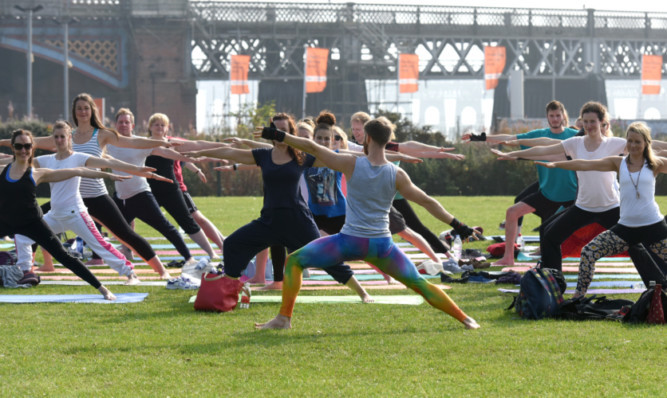 Nearly 100 people who took part in the outdoor yoga session for Heart Space.