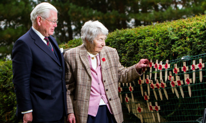 Lt Gen Sir Alistair Irwin and mother Elizabeth Irwin lay a cross in memory of Lt Lewis Cumming.