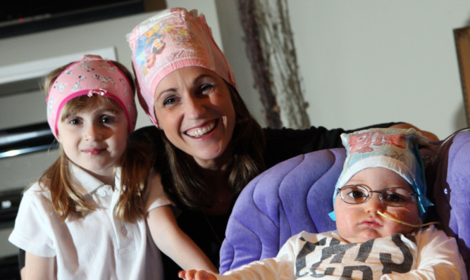 Blake McMillan with mum Jenny and sister Faye with their pants/nappies on their heads. A new charity challenge has started for Blake, with participants taking a selfie with their pants on their head.
